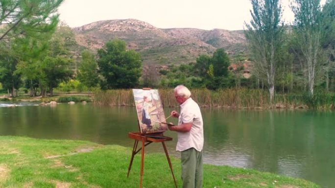 秋天在河边工作的老年绘画画家