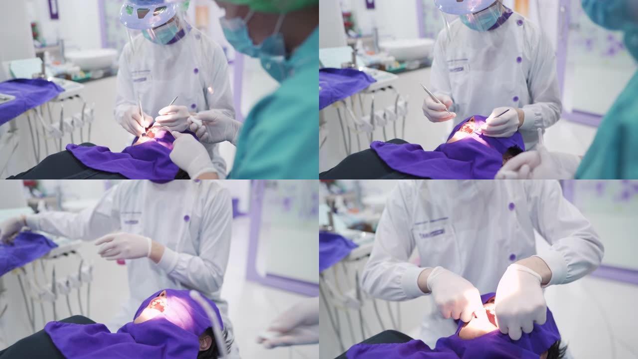 牙医使用牙线在人的嘴上处理牙垢 (牙结石)