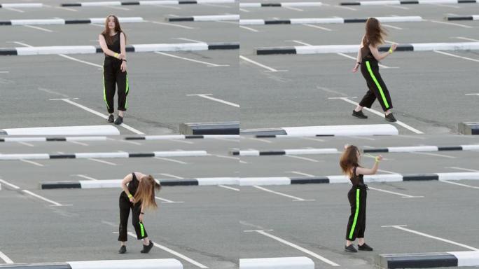 年轻开朗的长发女子在停车场跳舞嘻哈。表演现代青年舞蹈的壮观元素。慢动作