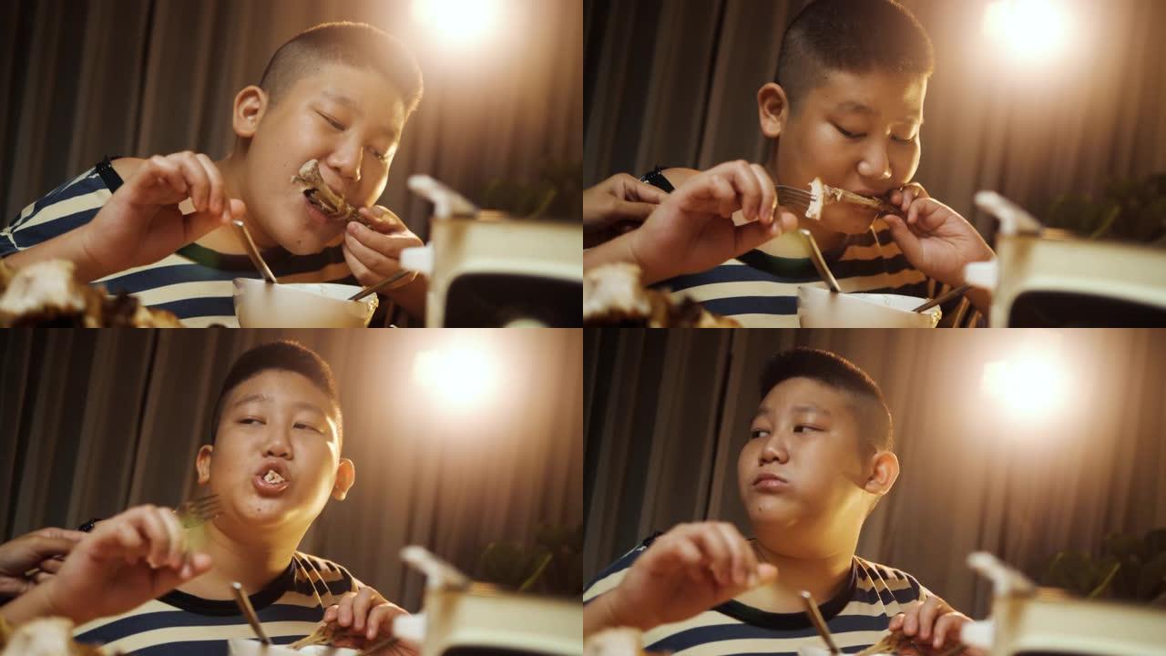 快乐的亚洲儿童晚上在家一起吃沙巴沙巴，生活方式理念。