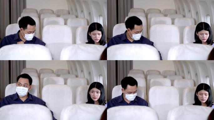 亚洲人坐在窗户附近的飞机椅子上后戴着口罩。健康保障航空旅行运输的概念新常态。