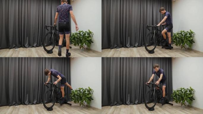 男子开始在smart trainer上室内骑自行车。对自行车教练进行男性培训。室内虚拟自行车概念