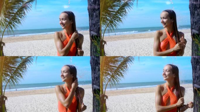 女孩在海边的海滩上淋浴下洗长发