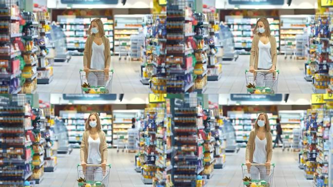 戴着医用口罩的美丽年轻女子带着一车杂货穿过超市。在检疫期间在商店购买杂货，自我隔离，冠状病毒，新型冠