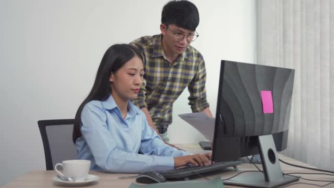 两个亚洲团队致力于编程和加密技术网站的开发，在办公室的办公桌上设计程序员。