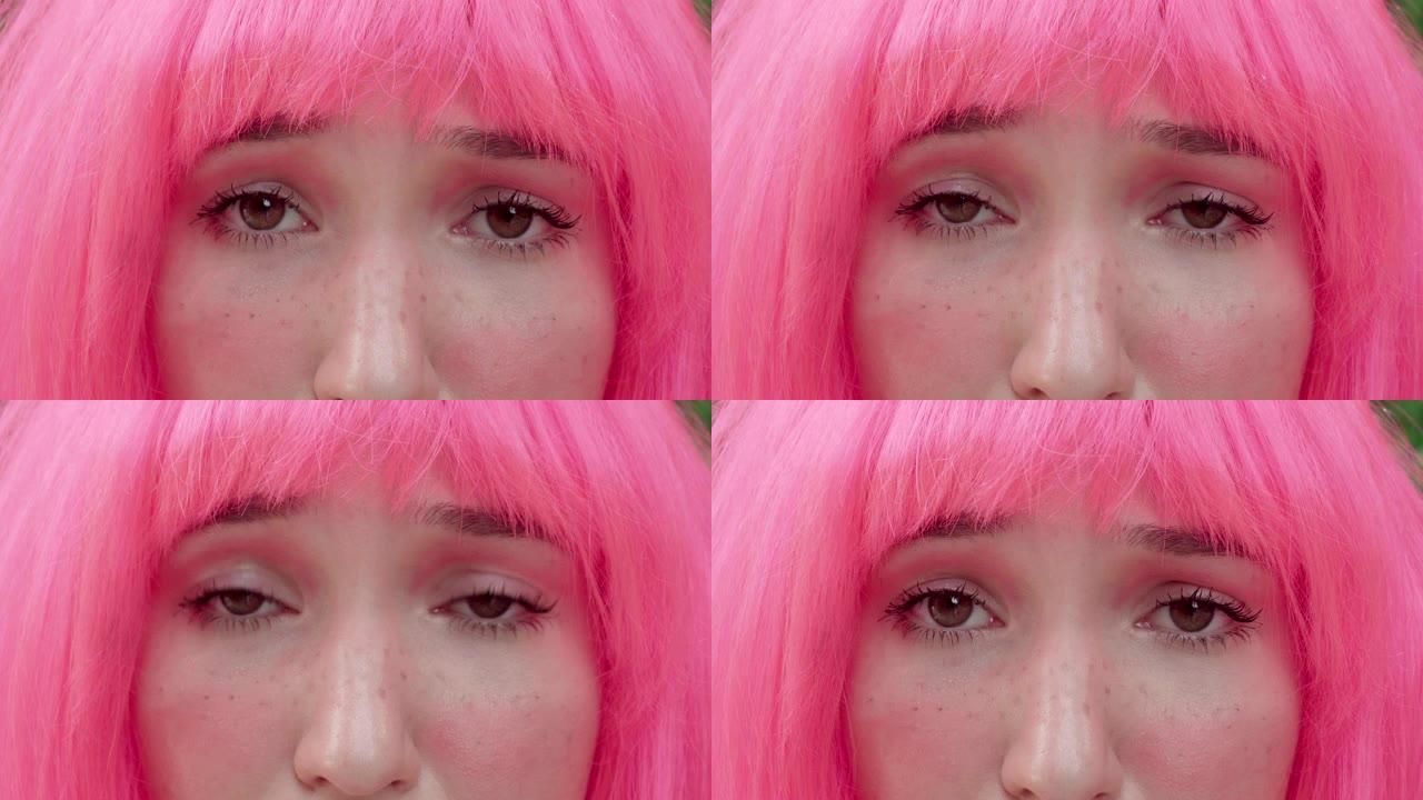 一个粉红色头发的女人看着相机的特写镜头。