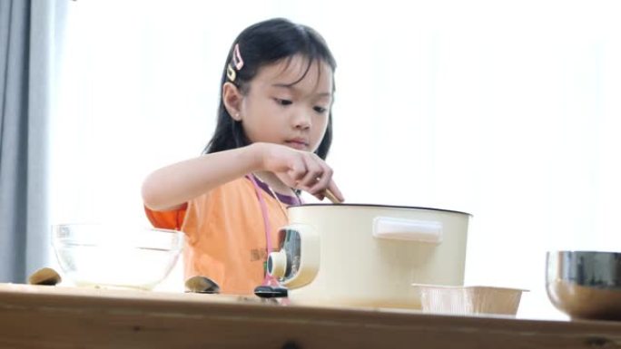 亚洲女孩在锅里搅拌食物，生活方式概念。