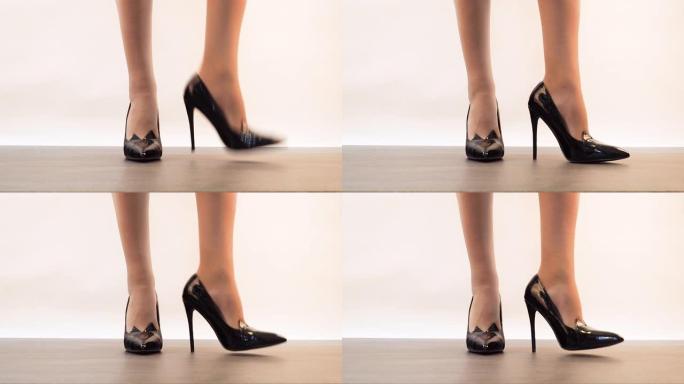 漂亮的黑色漆皮皮鞋，高跟鞋上的女人站着，然后改变她的位置。愤怒的女商人把脚趾敲在地板上。4k特写显示