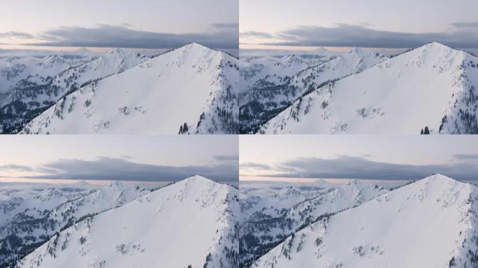 喀斯喀特山脉雪域冬季山地空中无人机视图雷尼尔山贝克山附近的多个山顶
