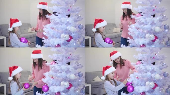 小女儿拿着很多粉红色的玻璃小玩意，她的母亲拿着小玩意，装饰着一棵枞树。