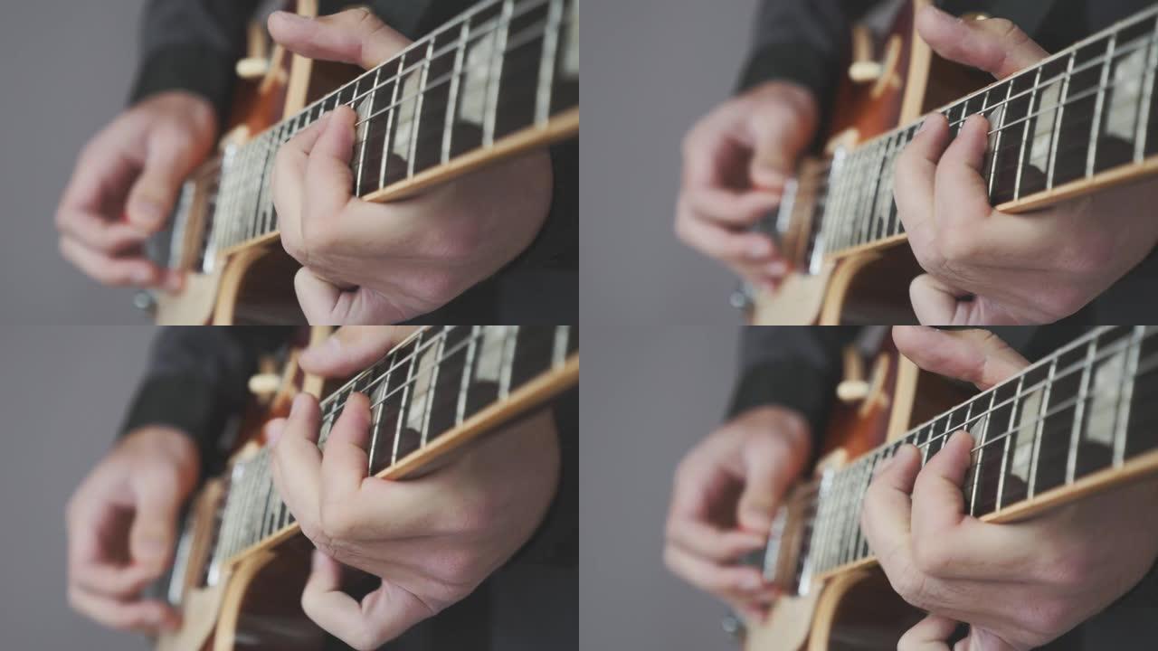用电吉他弹奏的男性手特写。吉他指板上的手指拿着拨片，弹奏和弦和独奏。乐器概念
