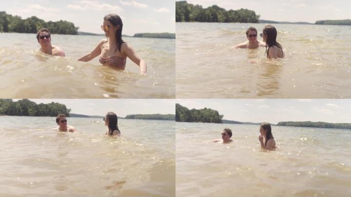 在炎热的夏日，一对夫妇在湖中玩耍