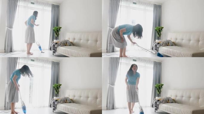 亚洲女性在家使用真空吸尘器清洁，生活方式理念。