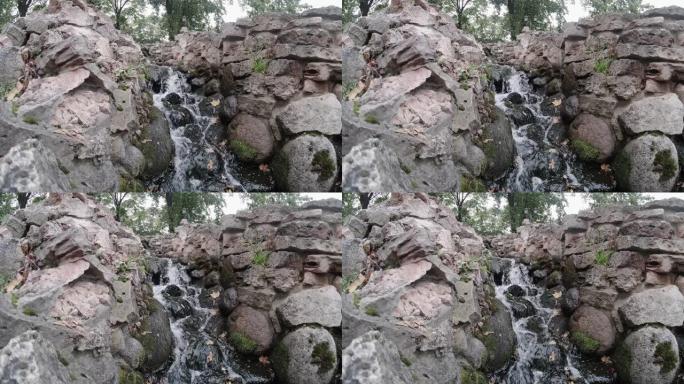 山上的森林瀑布。流经石头的清水特写。