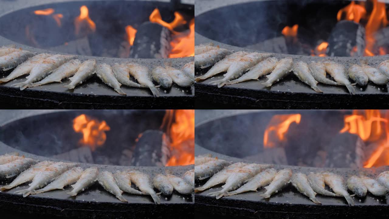 在美食节上用黑色烹饪欧洲臭鱼的过程: 特写
