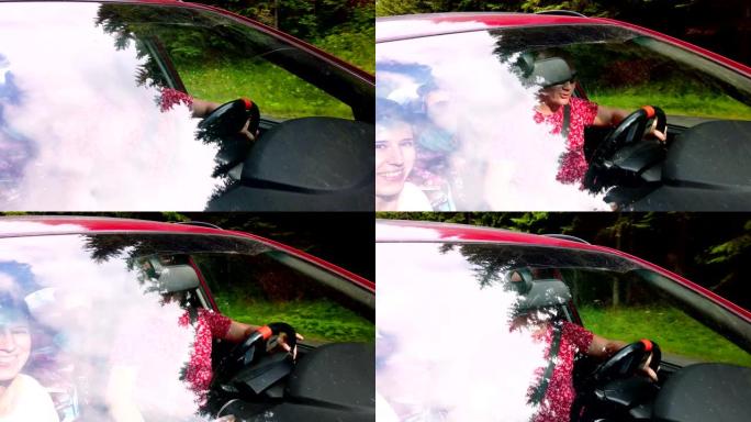 从外面看，通过汽车的挡风玻璃可以看到乘客。男子开车。树的顶部反射在挡风玻璃上。汽车在行驶