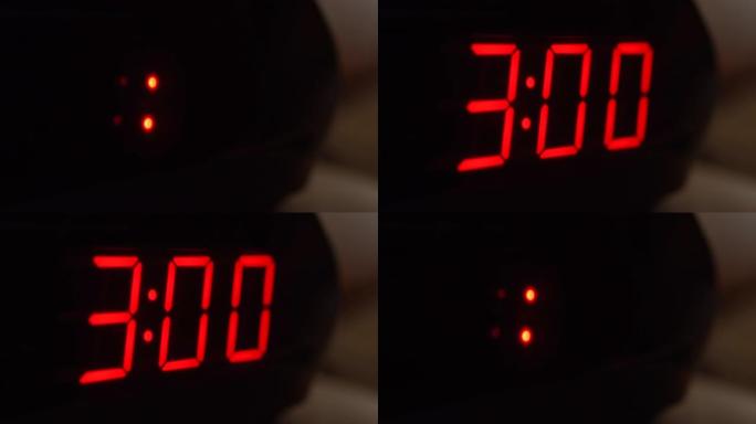 黑色数字时钟屏幕的特写显示3.00。黑色背景上闪烁红色数字。现代定时器系统和霓虹灯、电动报警装置