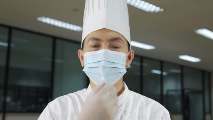 职业男厨师戴上医用口罩的肖像，因为新型冠状病毒肺炎