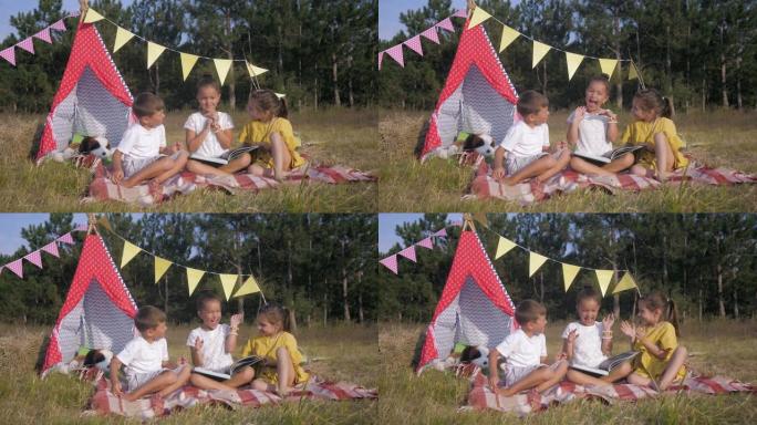 周末在森林里，快乐的朋友孩子们在比格瓦姆的背景下展示有趣的面孔和野餐书籍
