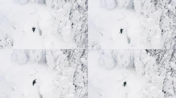 在冬季下雪的天气条件下，在滑雪场上方的滑雪者在深粉雪中徒步爬山的空中无人机