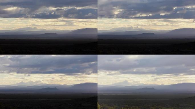 乌云在半沙漠农田上空移动。南非卡鲁的晨景。