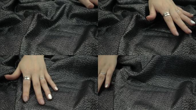在慢动作中触摸敏感织物。女人的手轻轻地抚摸纺织品。
