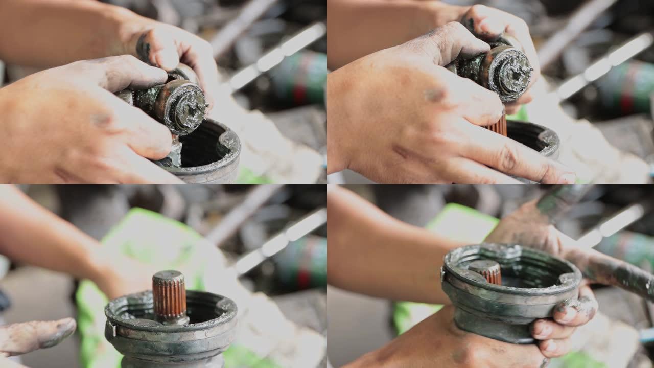 汽车机械师拆卸传动轴橡胶套的手