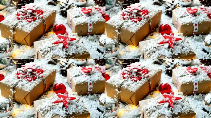 圣诞节和新年背景与礼物，丝带，球和雪上的不同装饰。用红星手纸包装的礼物。