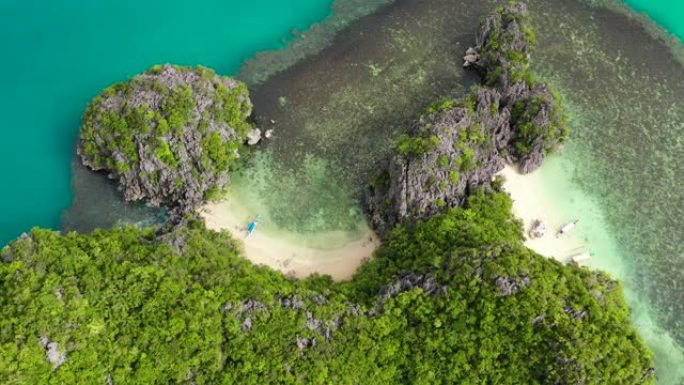 岩石岛，有一个白色的小海滩，鸟瞰图。菲律宾卡拉莫安群岛