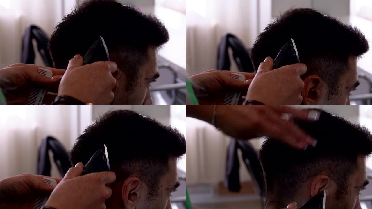 美发师正在为男性黑发客户进行男性机器理发