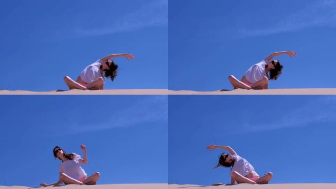 女人伸展坐莲花姿势沙滩倾斜侧瑜伽练习多风的天空。