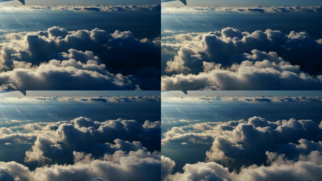 从蓝天的飞机窗户俯瞰云层。从飞机窗口可以看到蓝天白云。乘飞机旅行。