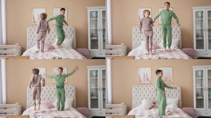 两个白人男孩在床上跳起来，开心地笑着和可爱的孩子儿子在卧室里玩有趣的活跃游戏。