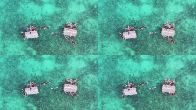 使用无人机的鸟瞰图，位于蓝海中部的海上吉普赛高跷屋，位于马来西亚沙巴，婆罗洲的仙本那。