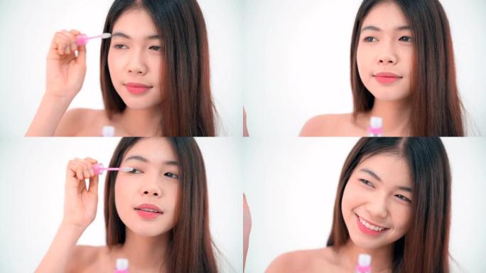 年轻的亚洲女性在镜子前化妆