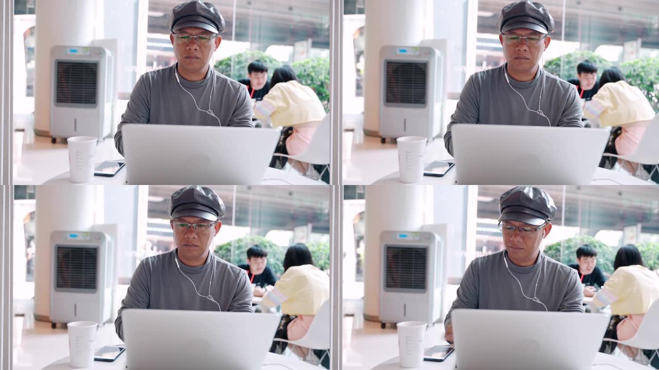 自由博客作者坐在一家咖啡店的网站上的文章中，男子键入指向计算机中的数据