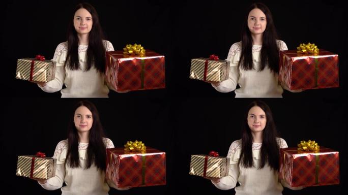 黑色背景上有礼品盒的年轻女子。带有白色丝带的礼品盒，用于新年快乐，圣诞快乐，情人节，生日