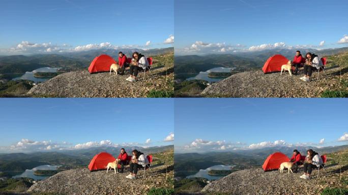 两个好朋友带着他们的狗在山顶露营。