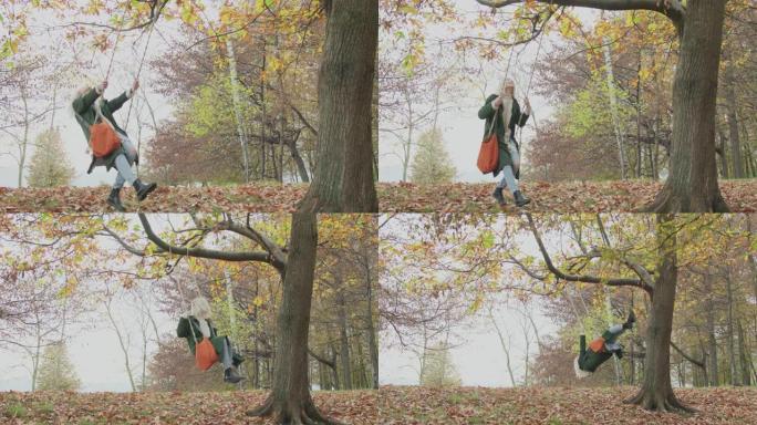 秋天，年轻美丽的女人像青少年一样在公园里摇摆。慢动作。女人在公园的一棵树附近摇摆。