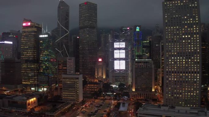 航拍移动摄影机拍摄香港市中心国际金融中心塔和维多利亚港夜间交通情况，4k视频