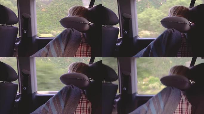 镜头年轻女子坐公共汽车睡觉。她在头下放了一个充气枕头。