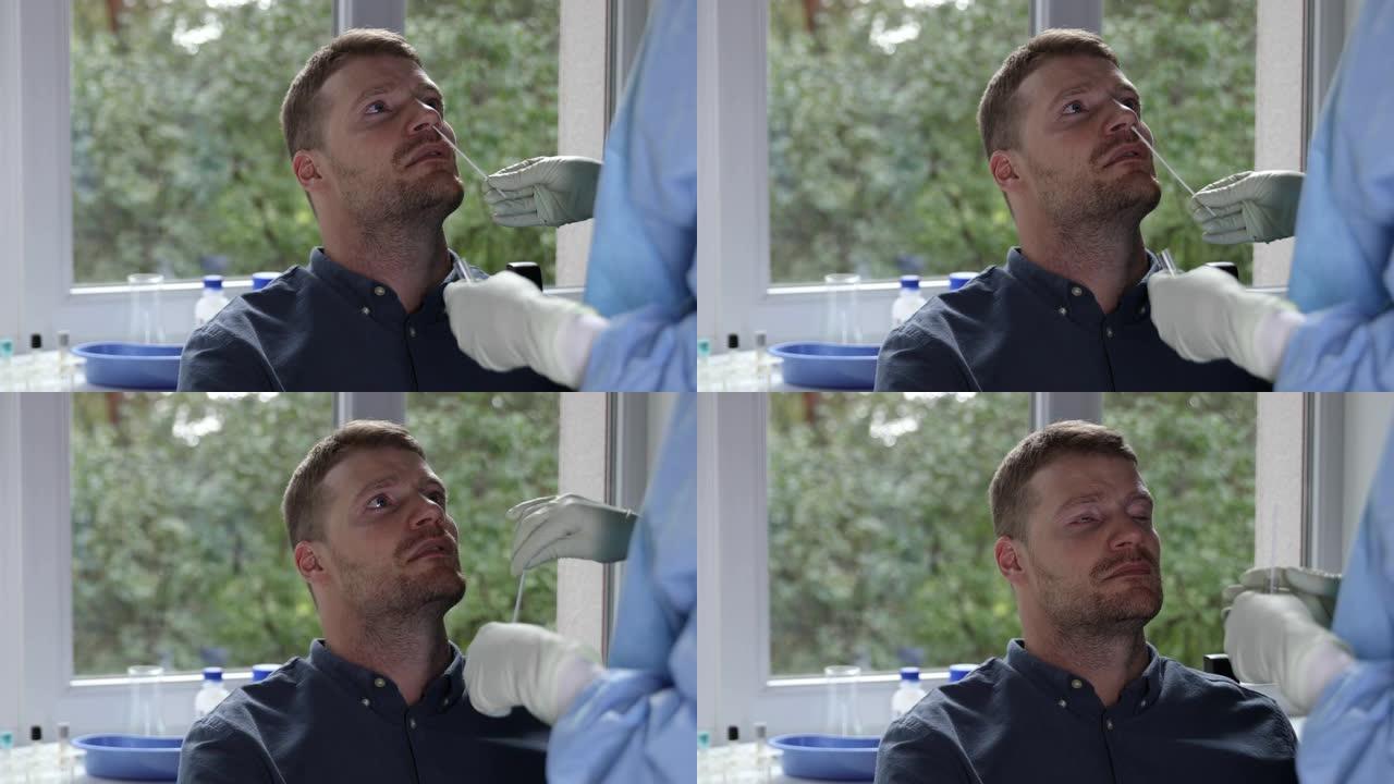 新型冠状病毒肺炎鼻拭子测试-医生在医院从男性患者鼻子中采集粘液样本