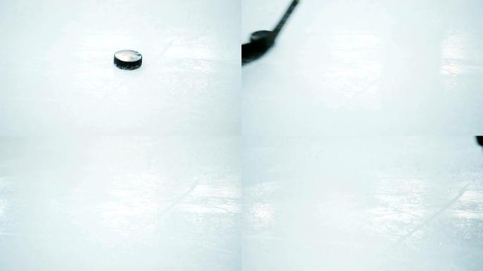 特写曲棍球运动员在冰场上用棍子移动冰球