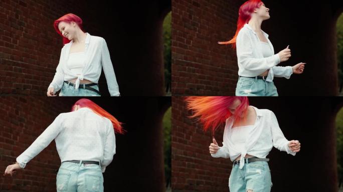快乐的女孩跳舞滑稽，挥舞着鲜红的头发
