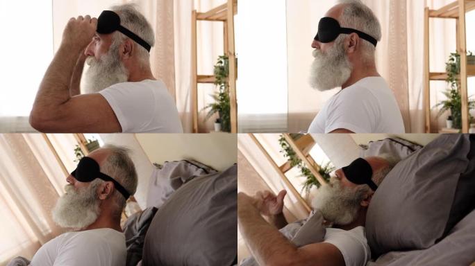 男子在床上戴着眼罩睡觉