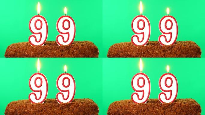 用99号点燃蜡烛的蛋糕。色度键。绿屏。隔离