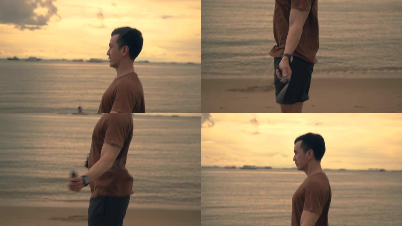 迷人的亚洲运动员在夏天美丽的日落时在海滩上锻炼时使用跳绳。