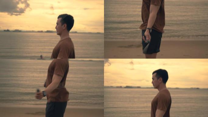 迷人的亚洲运动员在夏天美丽的日落时在海滩上锻炼时使用跳绳。