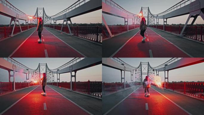 穿着非正式服装的年轻时髦女人在桥上骑着滑板，拿着燃烧的红色信号弹挥舞着它