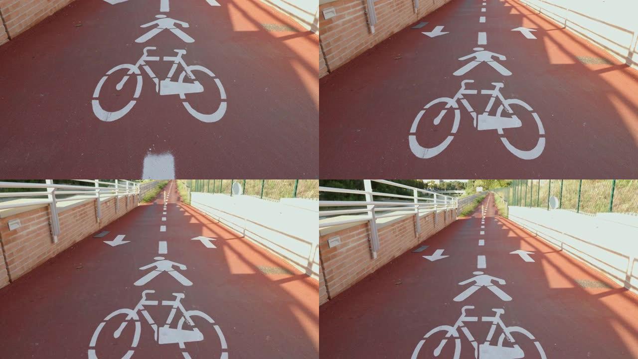 地面印有白色符号的红色自行车道，自行车经过